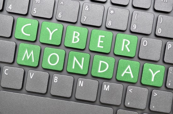 Computer keyboard with the letters spelling cyber monday highlighted in a green color and the rest of the keyboard's key are in the color black.